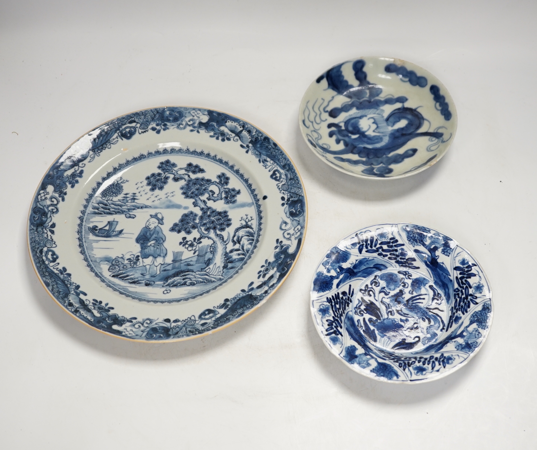 An 18th century Chinese export blue and white dish together with two others, largest 26cm